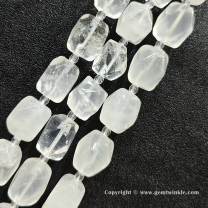 close up of quartz cylinder beads showing icy inclusions and wispy cloudiness