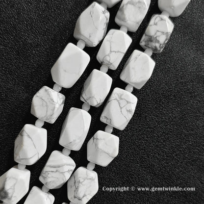 close up view of spiderweb matrix white magnesite faceted cylinder beads