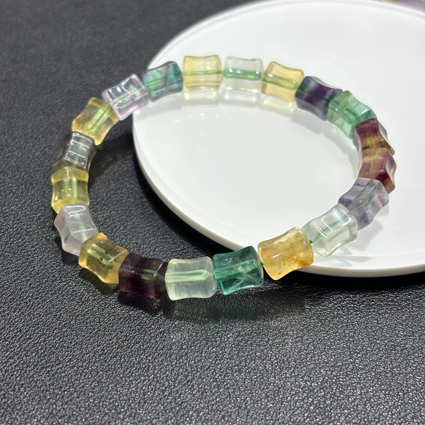 Closeup view of the natural fluorite beads, showing the intricate details and crystal clarity of the multicolor bamboo beads.