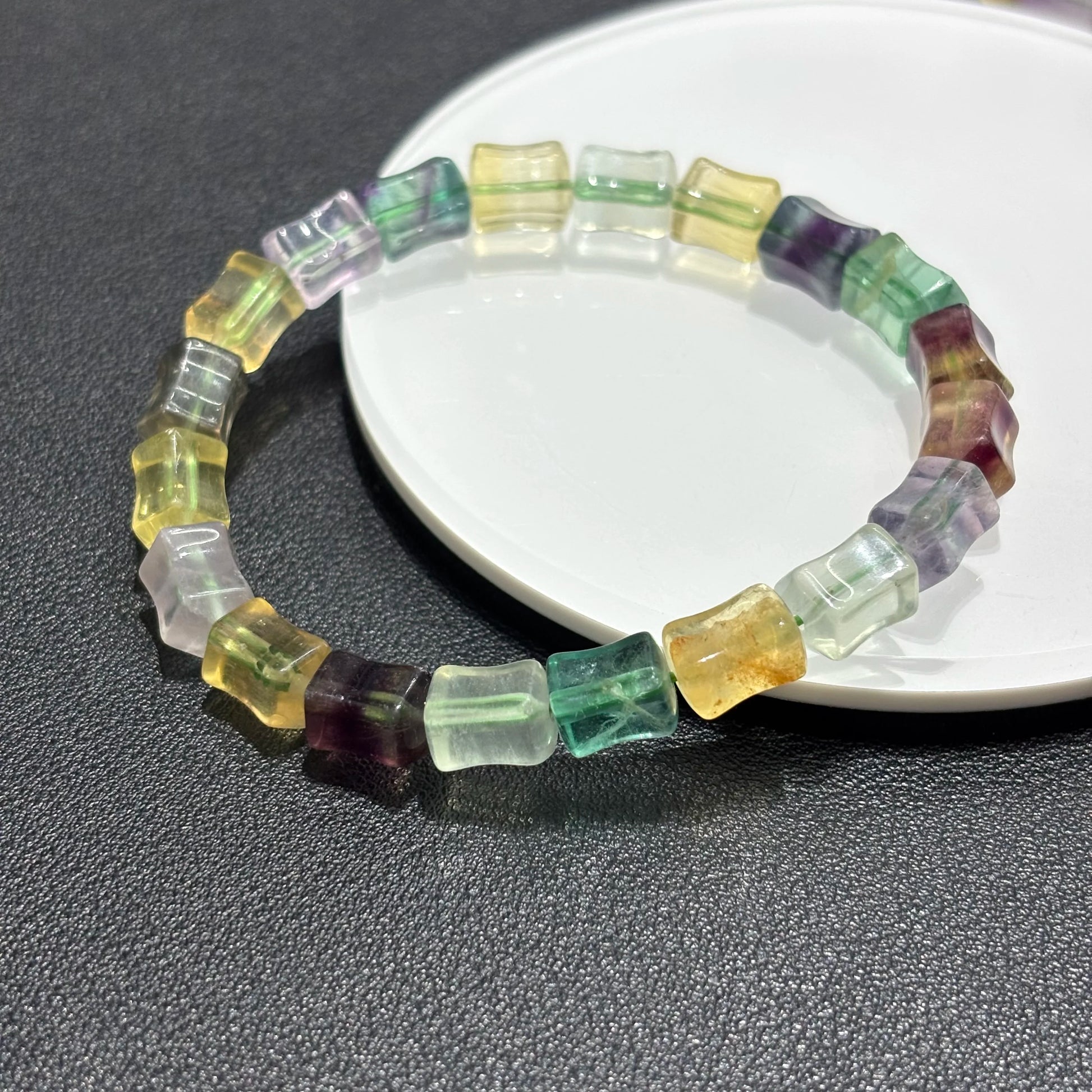 Closeup view of the natural fluorite beads, showing the intricate details and crystal clarity of the multicolor bamboo beads.