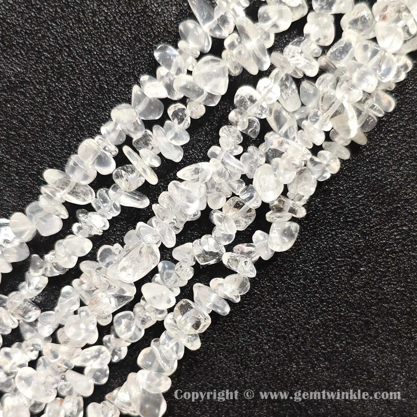 Close up view of tumbled cloudy white quartz freeform nugget chip beads