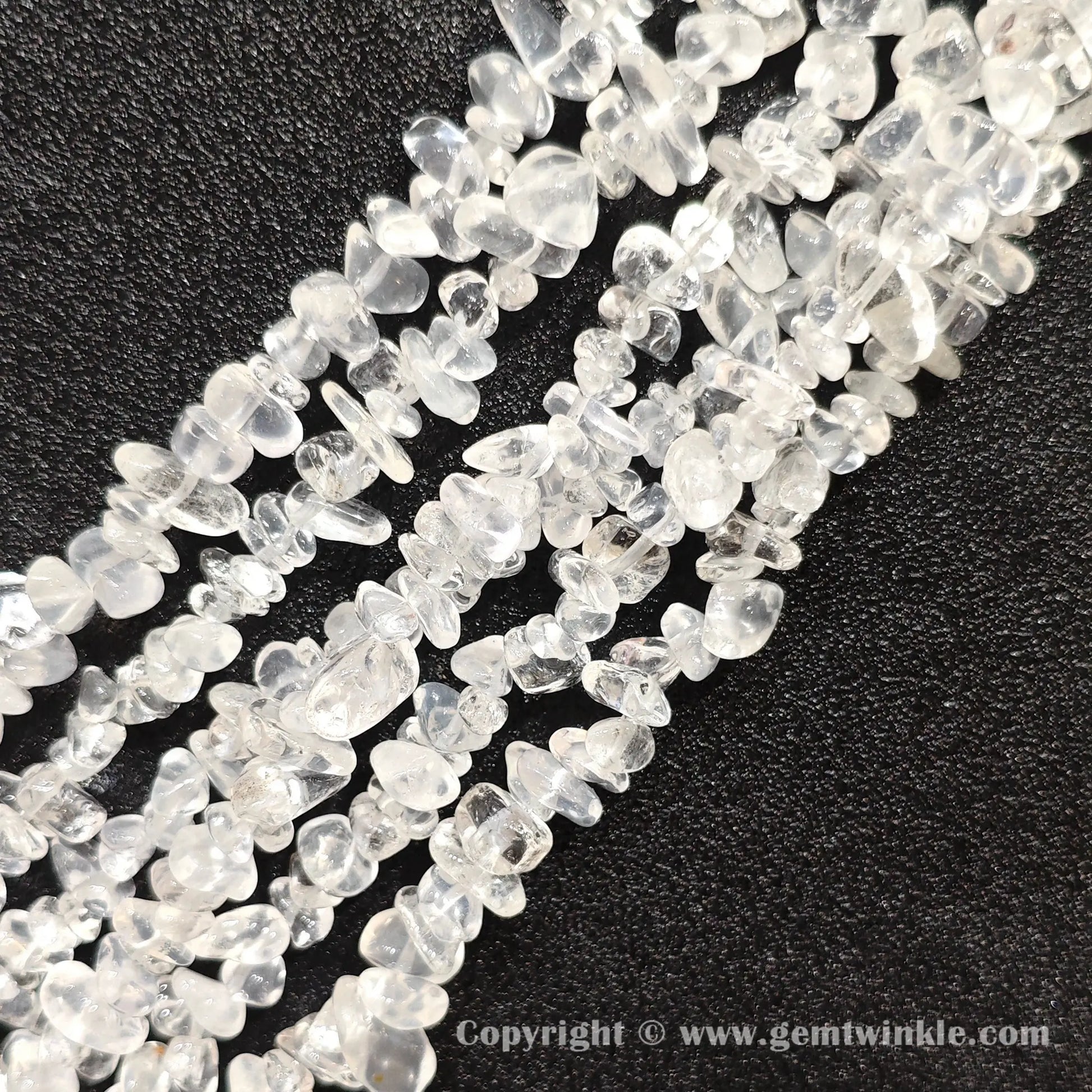 Close up view of tumbled cloudy white quartz freeform nugget chip beads