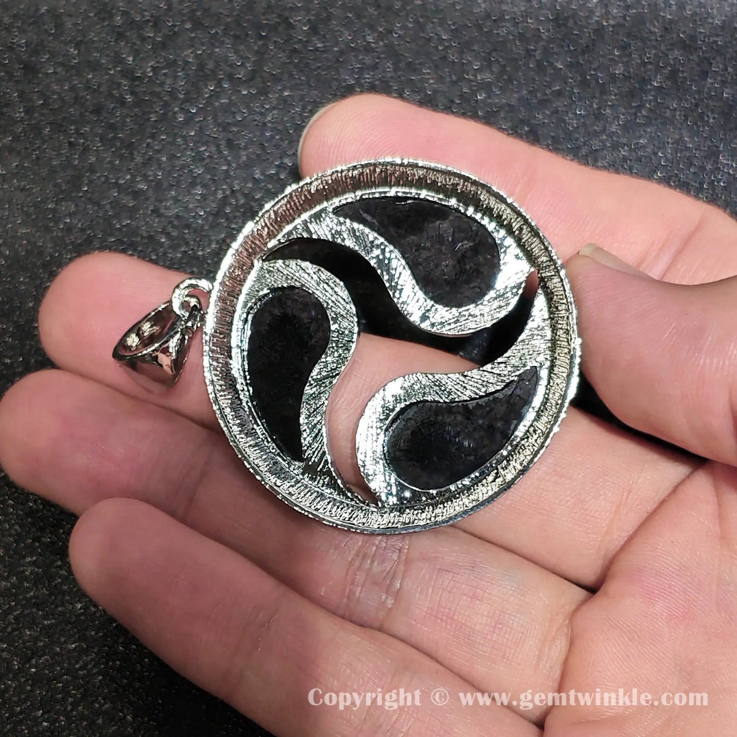 Back view showing openwork alloy structure and dark support lining of 40mm mosaic shell charm