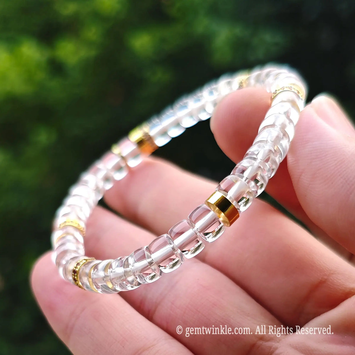 Macro close-up of 6mm faceted clear quartz beads paired with vintage bronze alloy spacer elements