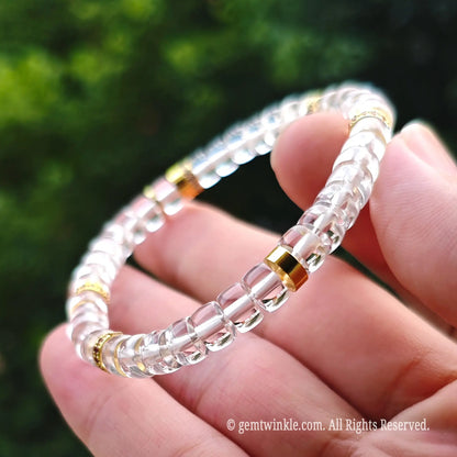 Macro close-up of 6mm faceted clear quartz beads paired with vintage bronze alloy spacer elements