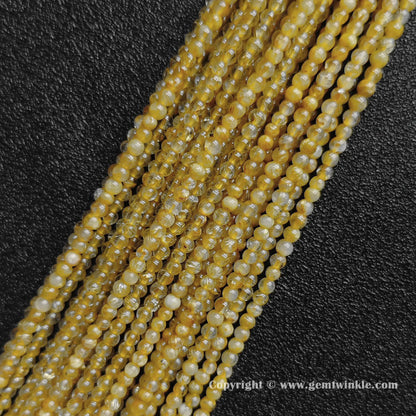 Four delicate strands of un-dyed 3mm dainty jewelry beads displaying dense B grade golden needle inclusions inside real quartz rounds from factory supplier