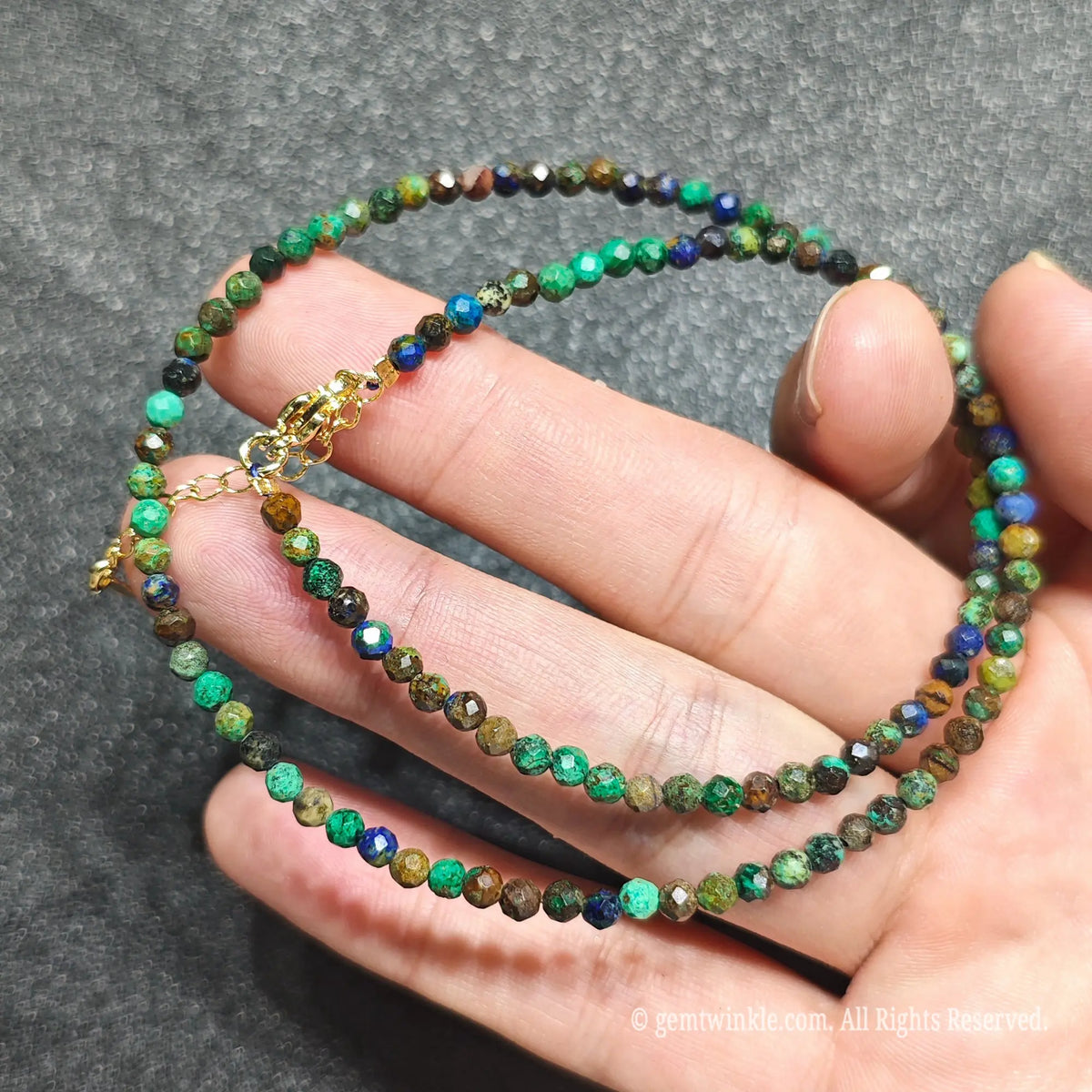 Coiled 3mm faceted azurite malachite gemstone necklace held across fingers for boho necklace layering