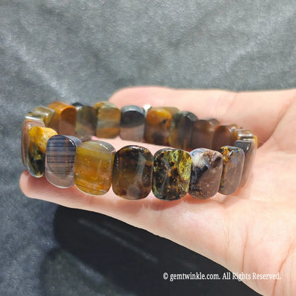 Perspective shot of a dark boho multicolor pietersite flat bead wristlet highlighting natural mineral texture[cite: 6]