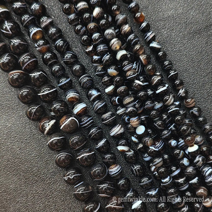Multiple strands of deep brown and black banded agate loose gemstone beads from Donghai crystal market with rich contrast bands
