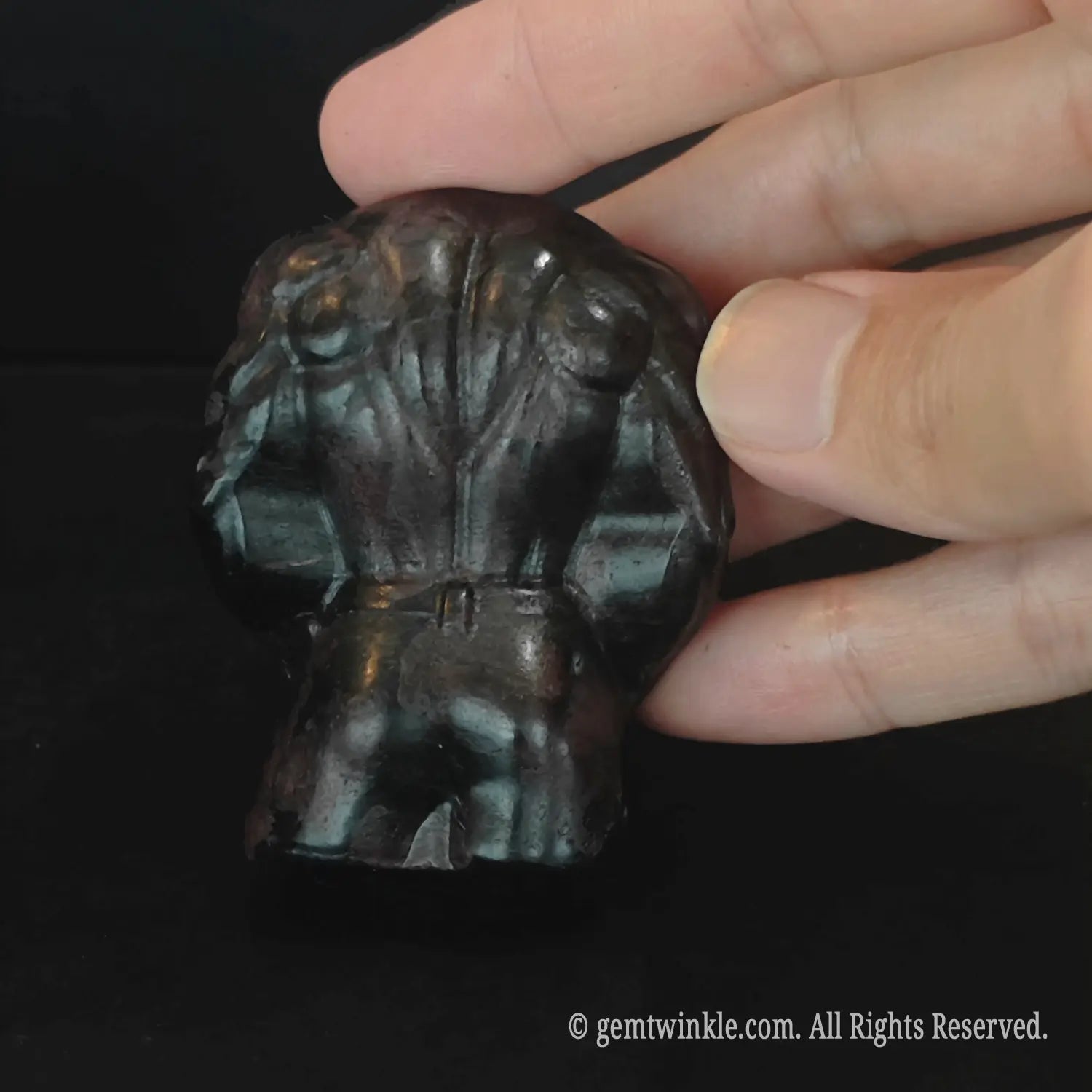 Back view of dark polished natural stone fitness man body figurine