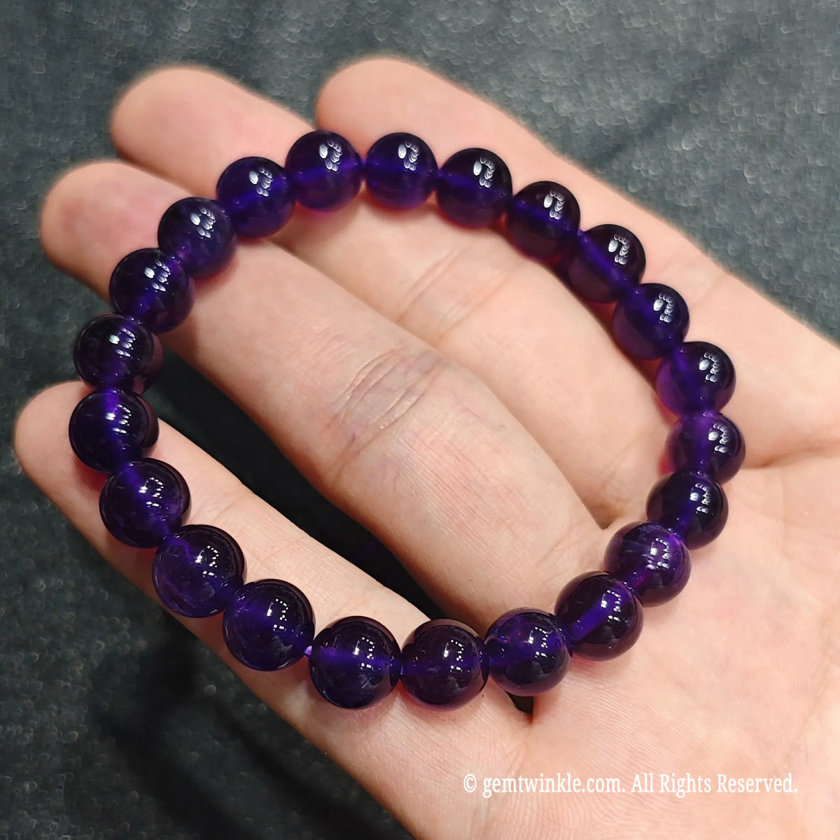 Side angle perspective of deep violet quartz spheres showing translucent clarity and round bead uniformity[cite: 8]