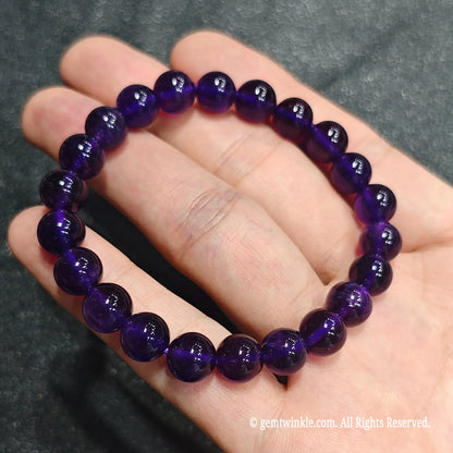 Side angle perspective of deep violet quartz spheres showing translucent clarity and round bead uniformity[cite: 8]