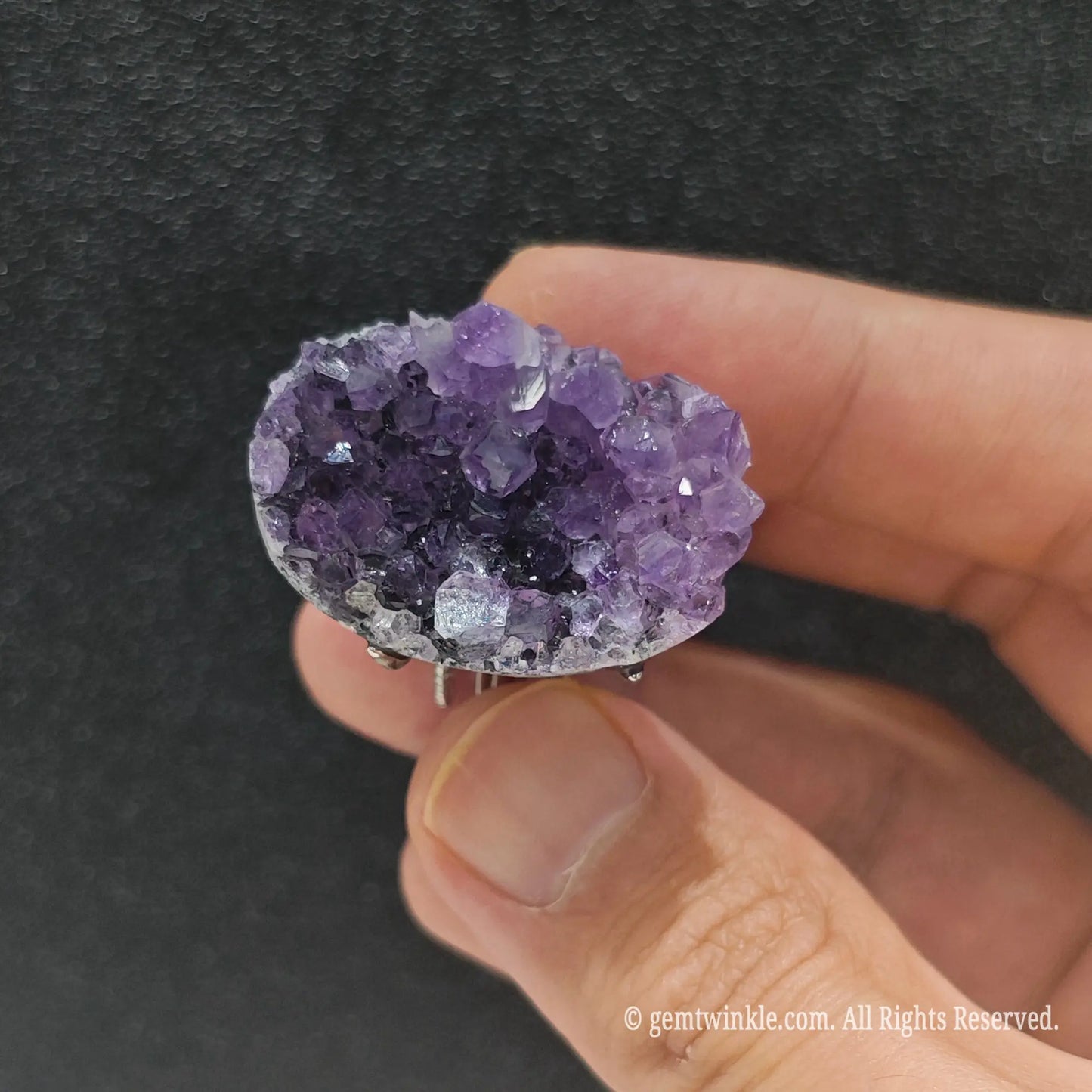 Deep purple amethyst statement ring top view on finger displaying 25-35mm raw geode crystal cluster formation