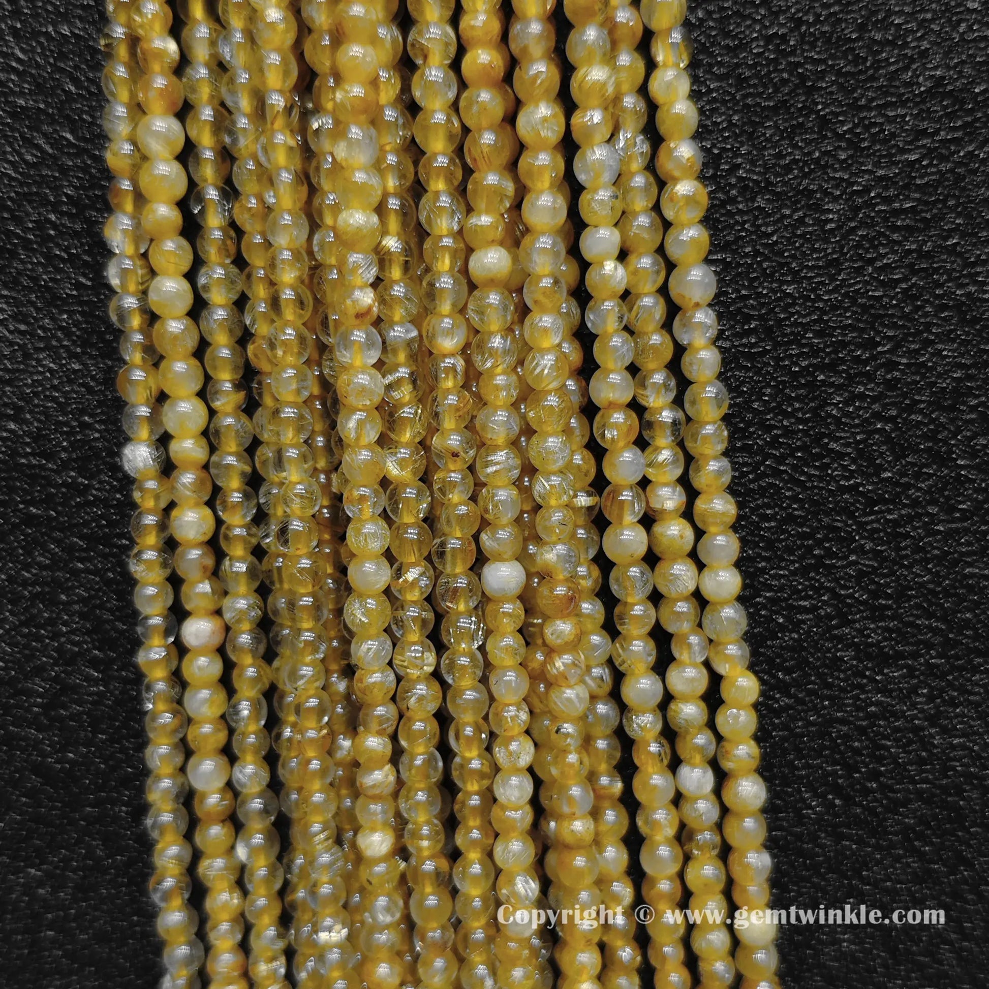 Detailed shot of real B grade 3mm small crystal beads with commercial matrix and distinct thick gold rutilated hair needles for delicate layering designs