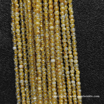 Detailed shot of real B grade 3mm small crystal beads with commercial matrix and distinct thick gold rutilated hair needles for delicate layering designs