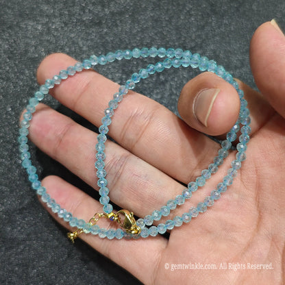 Detailed view of 3mm micro faceted sky blue topaz necklace showing multi-angle light reflection