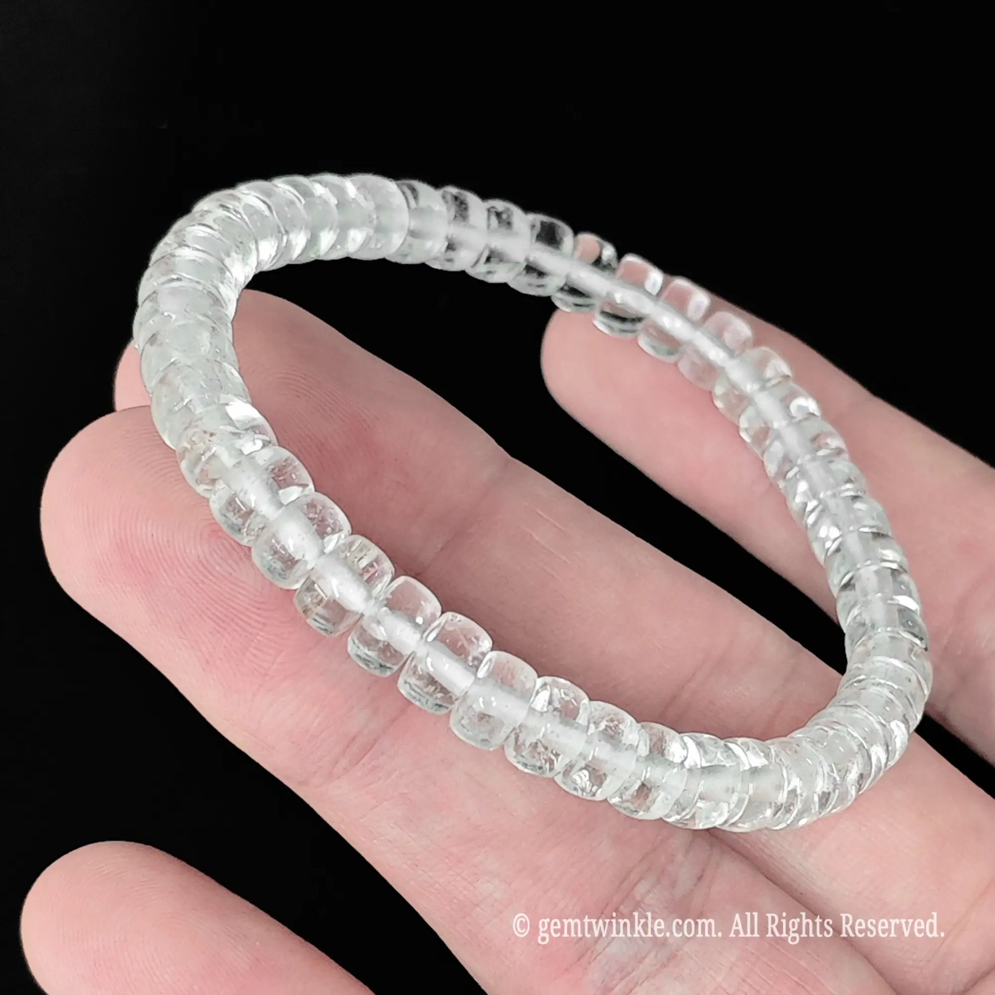 Delicate clear quartz abacus bead stackable bracelet styled on wrist displaying minimalist clear stone design