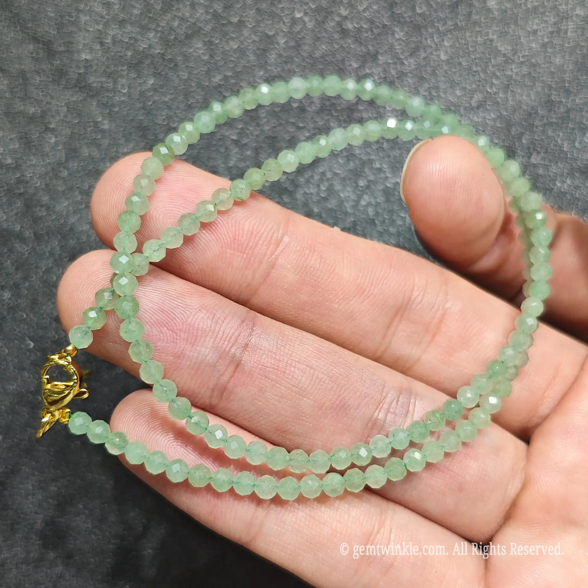 Detailed view of 3mm micro faceted green aventurine necklace showing multi angle glass shimmer and clarity