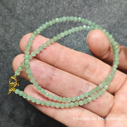 Detailed view of 3mm micro faceted green aventurine necklace showing multi angle glass shimmer and clarity