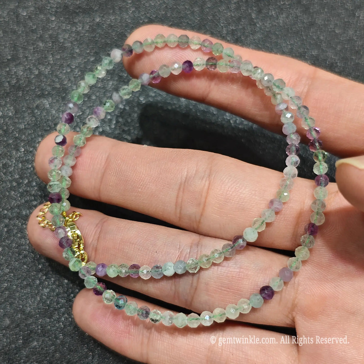 Detailed view of 3mm micro faceted rainbow fluorite necklace showing multi angle glass light reflections