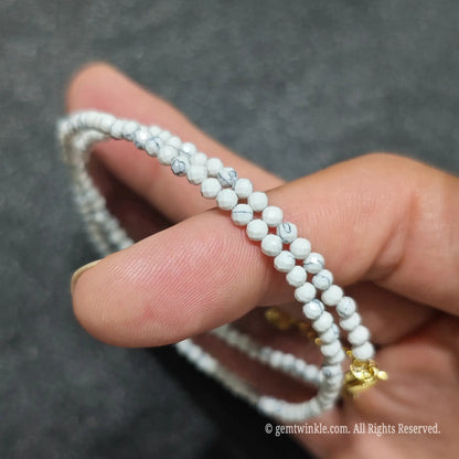 Detailed view of 3mm micro faceted white turquoise necklace showing subtle light reflections and marble texture