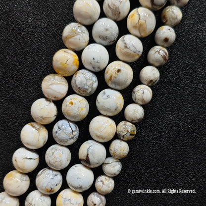 untreated dendritic blue opal crystal round beads strands showing natural black veins and yellow brown patches
