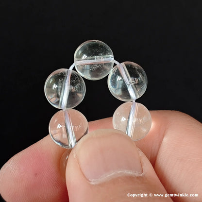 Grade A crystal quartz spherical loose beads sourced from Donghai market, showcasing beautiful light refraction, excellent gloss, and mild internal cloudiness