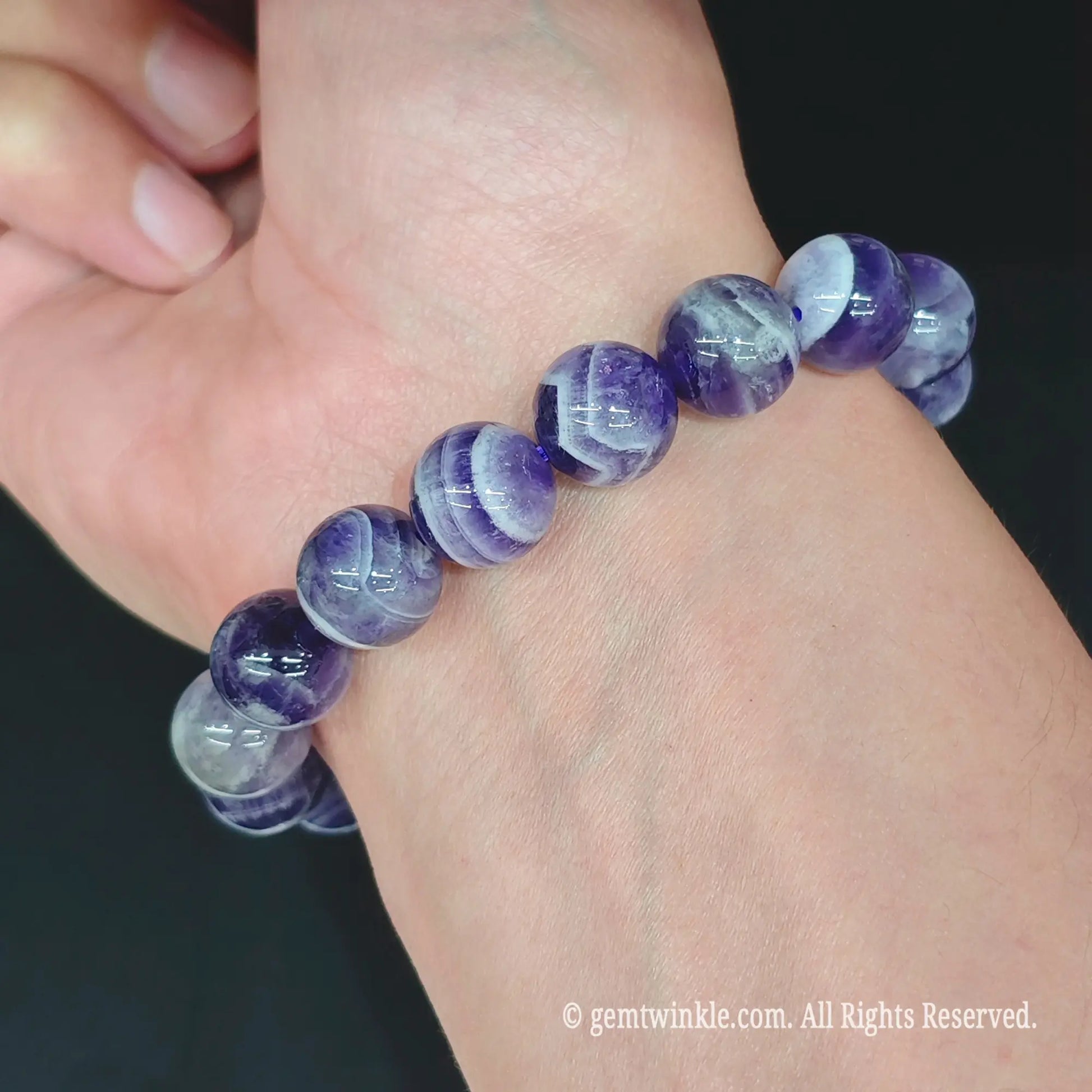 Dream amethyst round bead stretch bracelet styled on wrist displaying vibrant purple color and comfortable fit