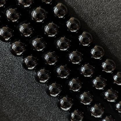 Close up of glossy Dyed Black Agate round beads for jewelry making