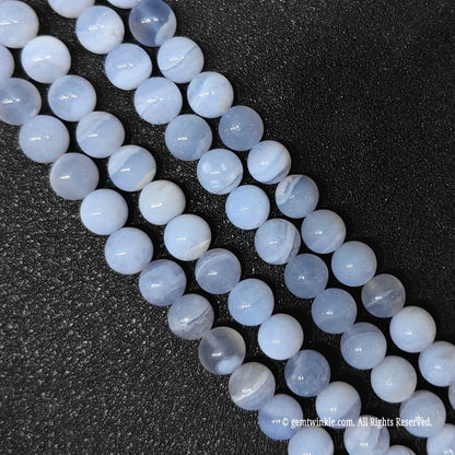 Inspecting a batch of dyed blue chalcedony crystal beads from 10mm to 12mm with natural agate base for store size chart validation