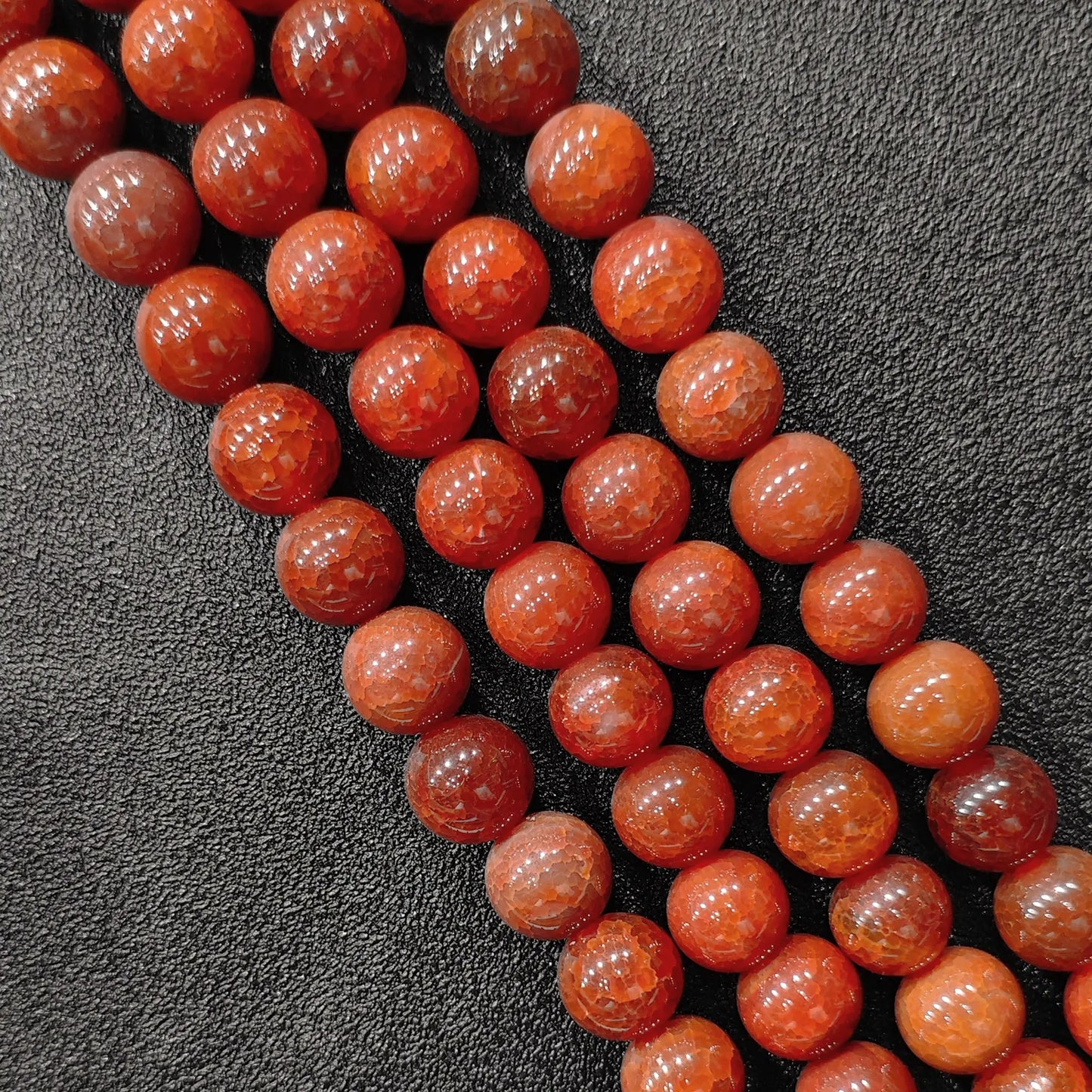 Detailed macro view of dyed red dragon veins agate crackled round beads showcasing deep crimson spiderweb matrix in image_bd2828.jpg