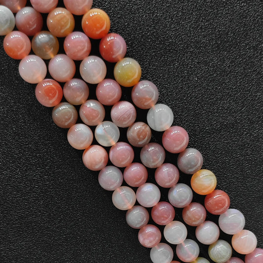 Close up view of dyed yanyuan agate smooth round beads showcasing vibrant pastel candy tones over a genuine natural base in image_bd9cc1.jpg