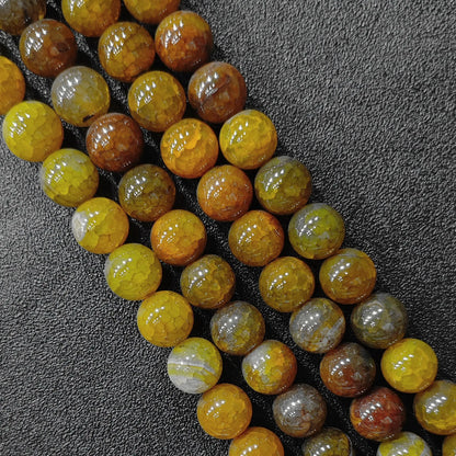Detailed close up of dyed yellow dragon veins agate crackled round beads showcasing spiderweb pattern in image_bcbf2c.jpg