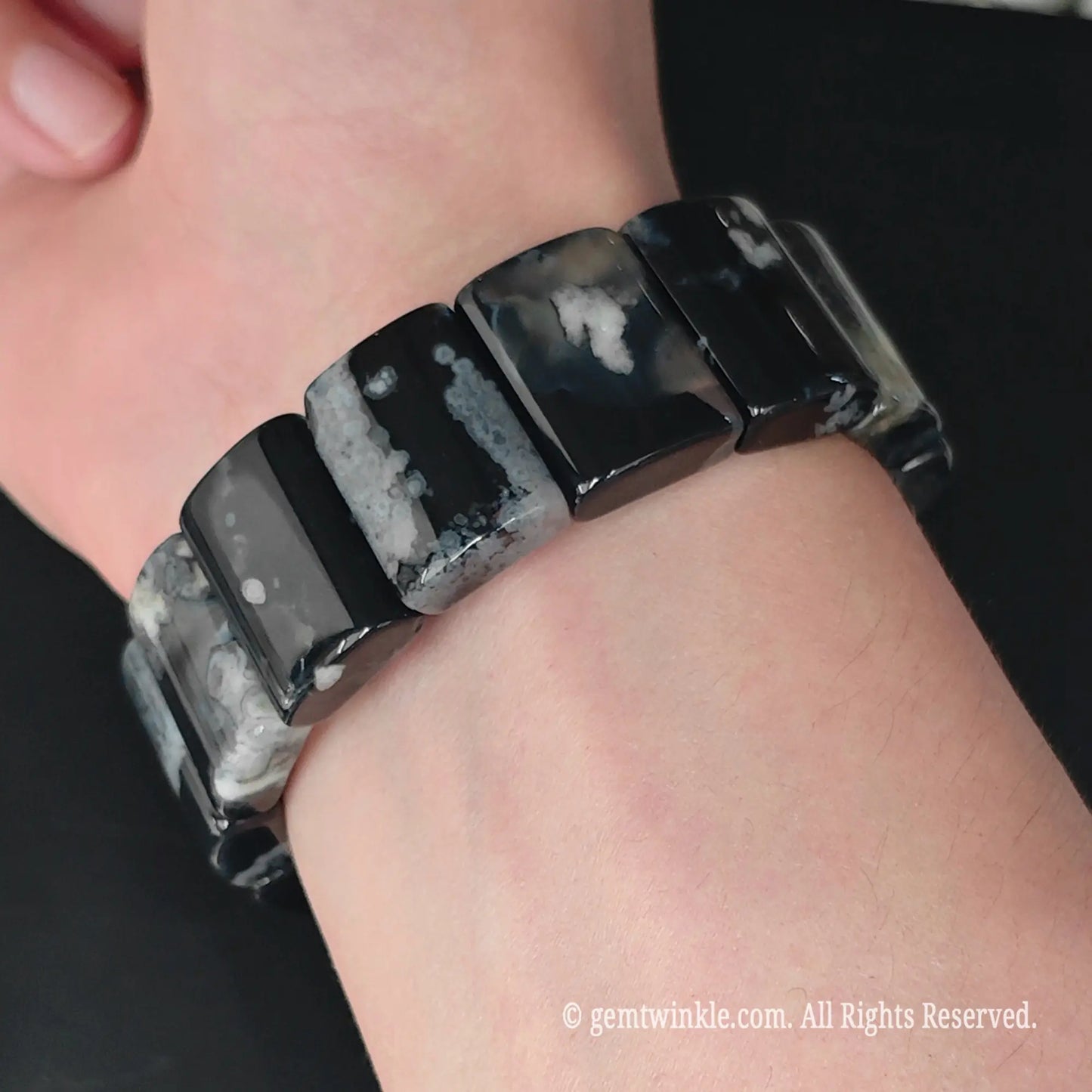 Dyed black sakura flower agate rectangle plate stretch bracelet styled on wrist displaying monochrome contrast