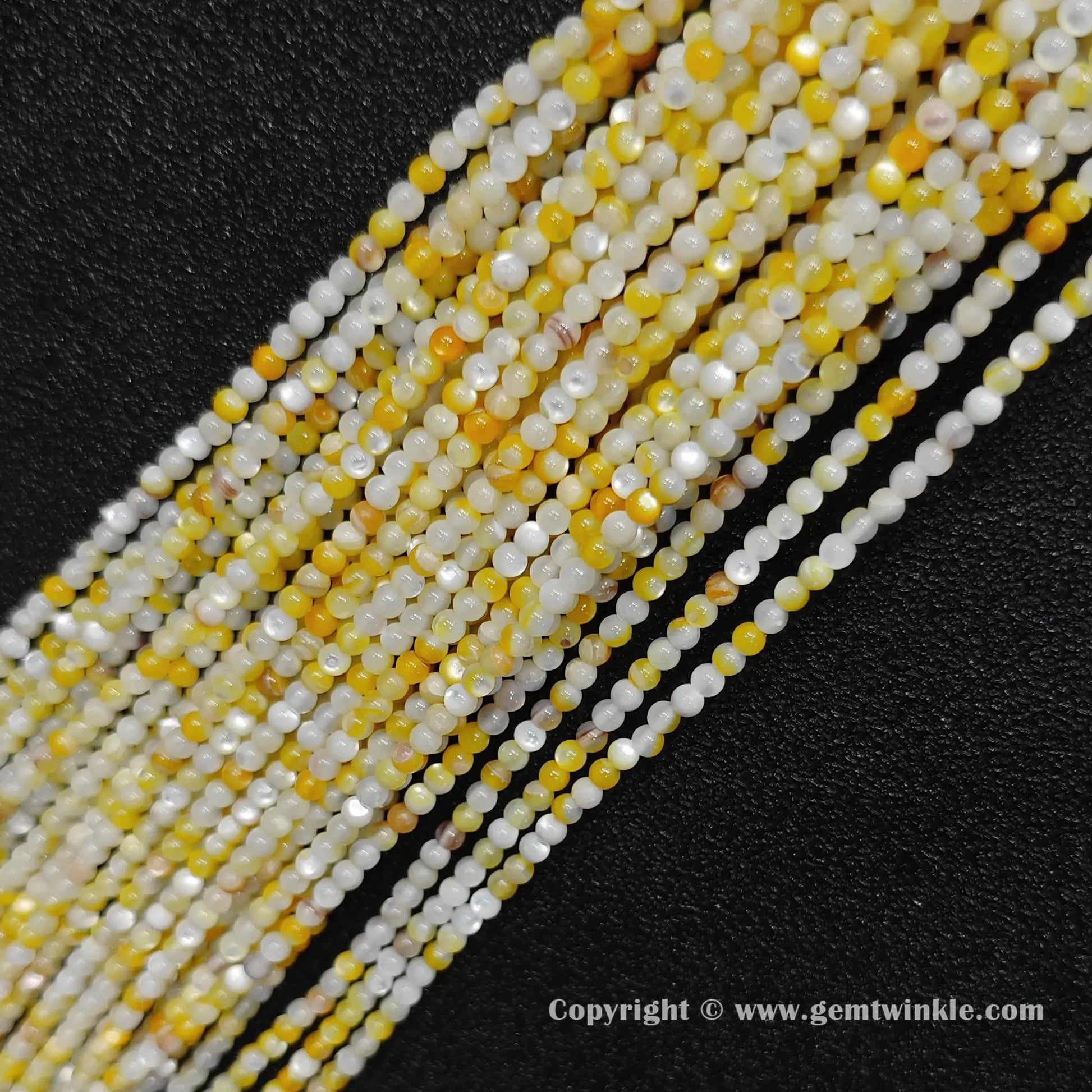 multiple strands of 2mm yellow mother of pearl shell seed beads for jewelry making
