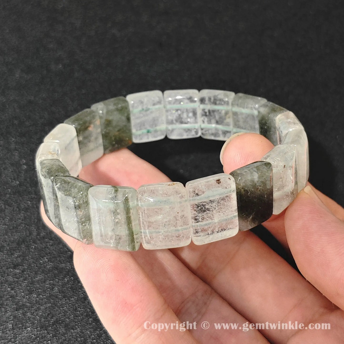 natural lodolite garden quartz bangle plate bracelet displayed over palm highlighting cloudy quartz structure