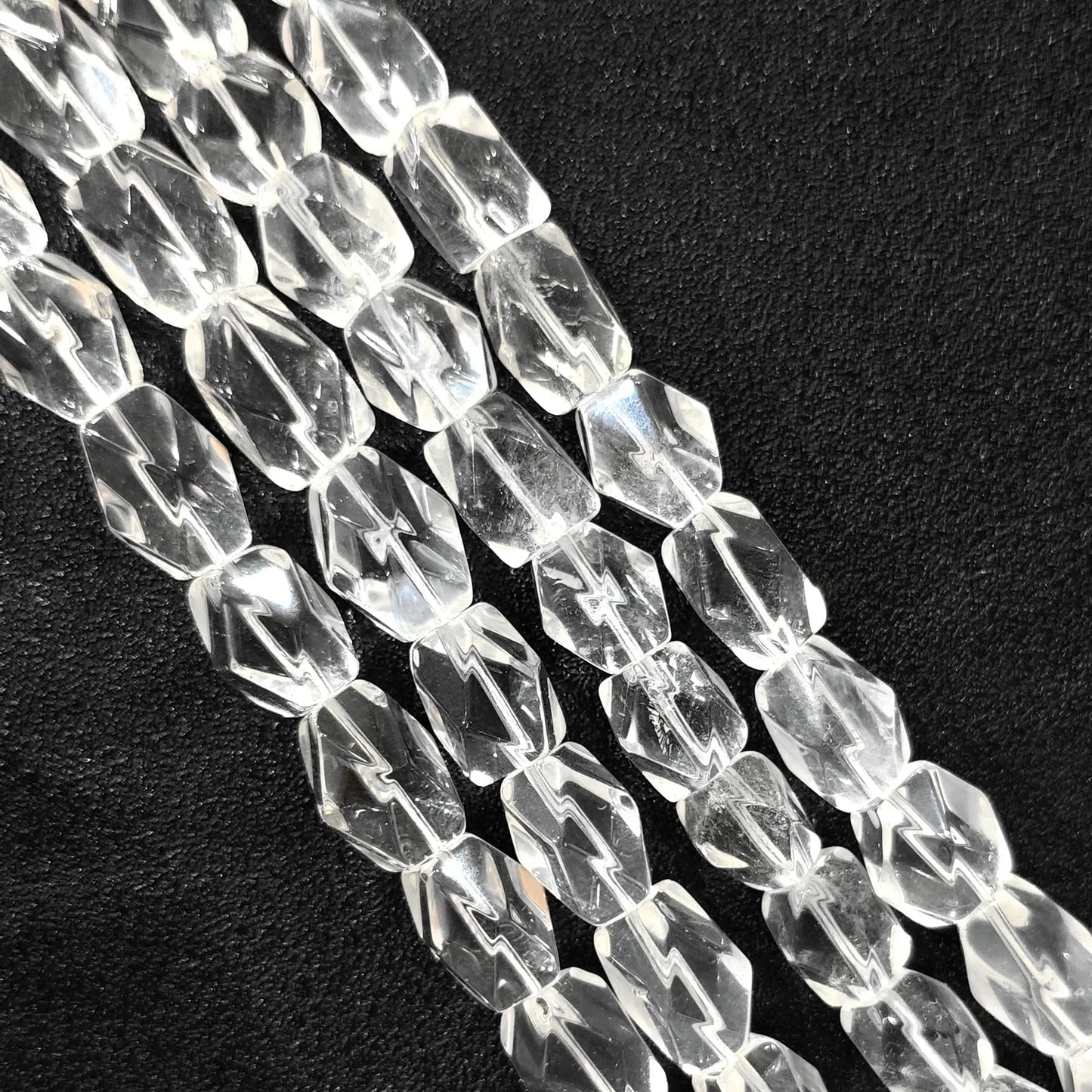 Strand of B-grade natural clear quartz faceted freeform barrel beads 15mm