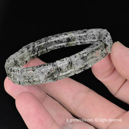 side view of 10mm pyramid faceted green mica clear quartz segment stretch bracelet