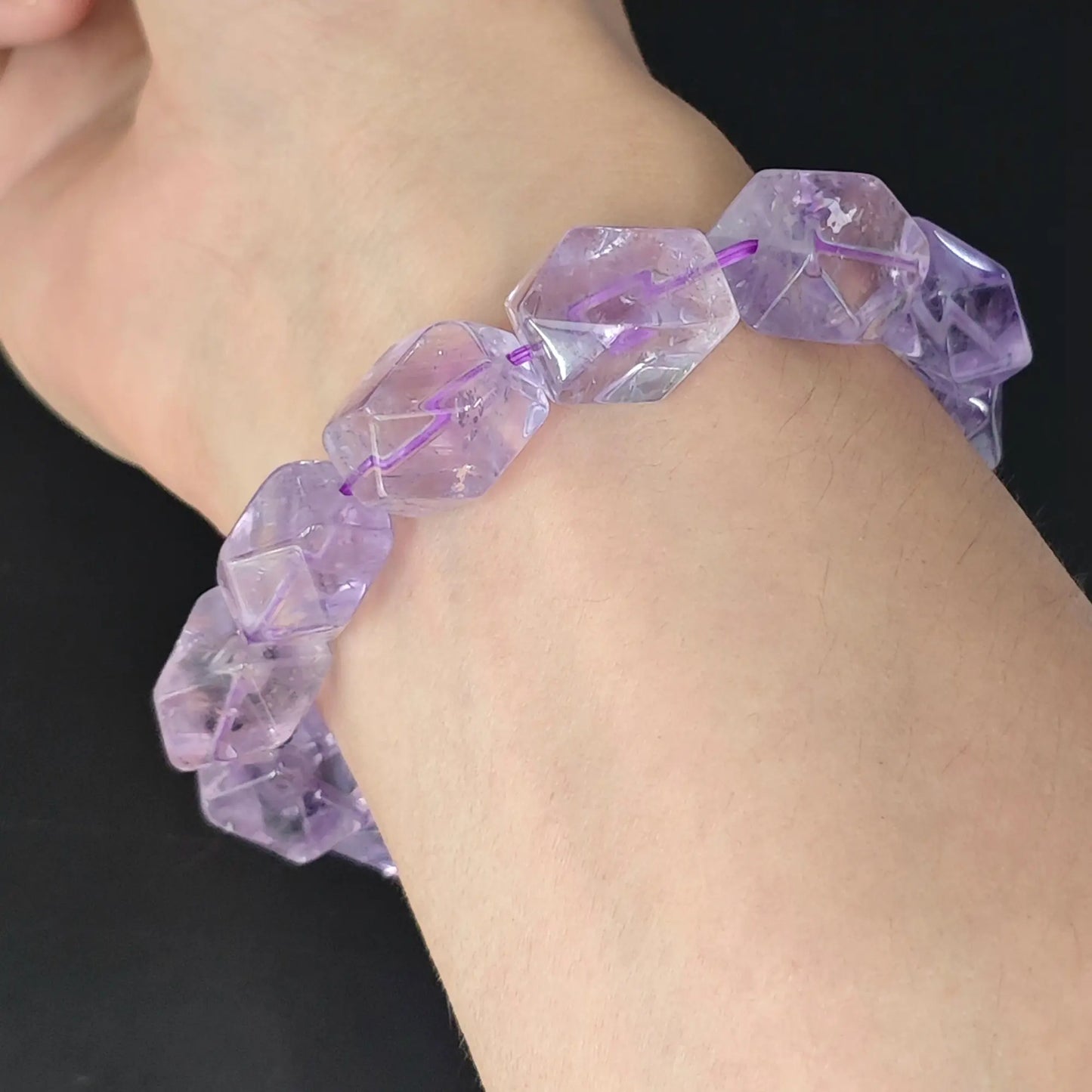 side view of faceted lavender amethyst geometric nugget stretch bracelet on wrist