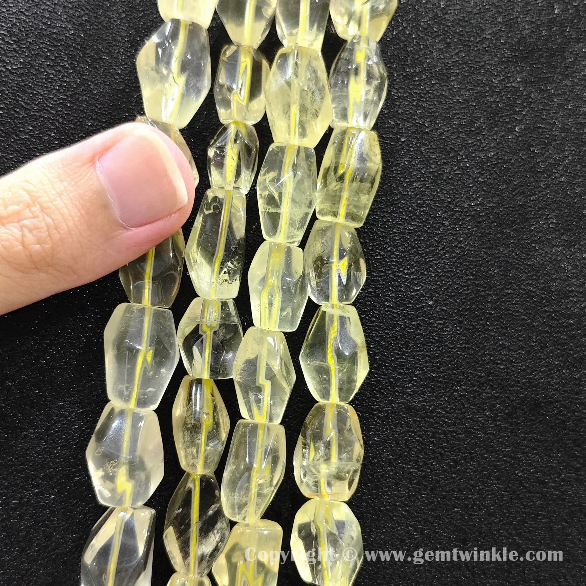 Vertical layout of faceted lemon quartz freeform nugget beads showing yellow brilliance