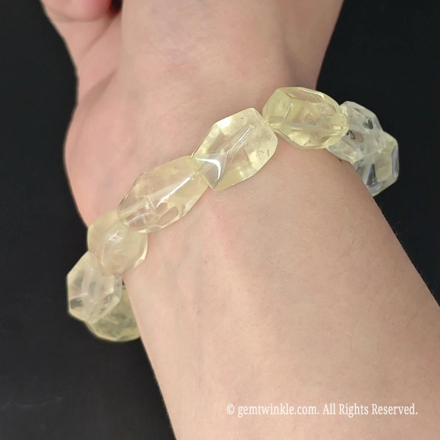 side view of faceted lemon quartz geometric nugget stretch bracelet worn on wrist