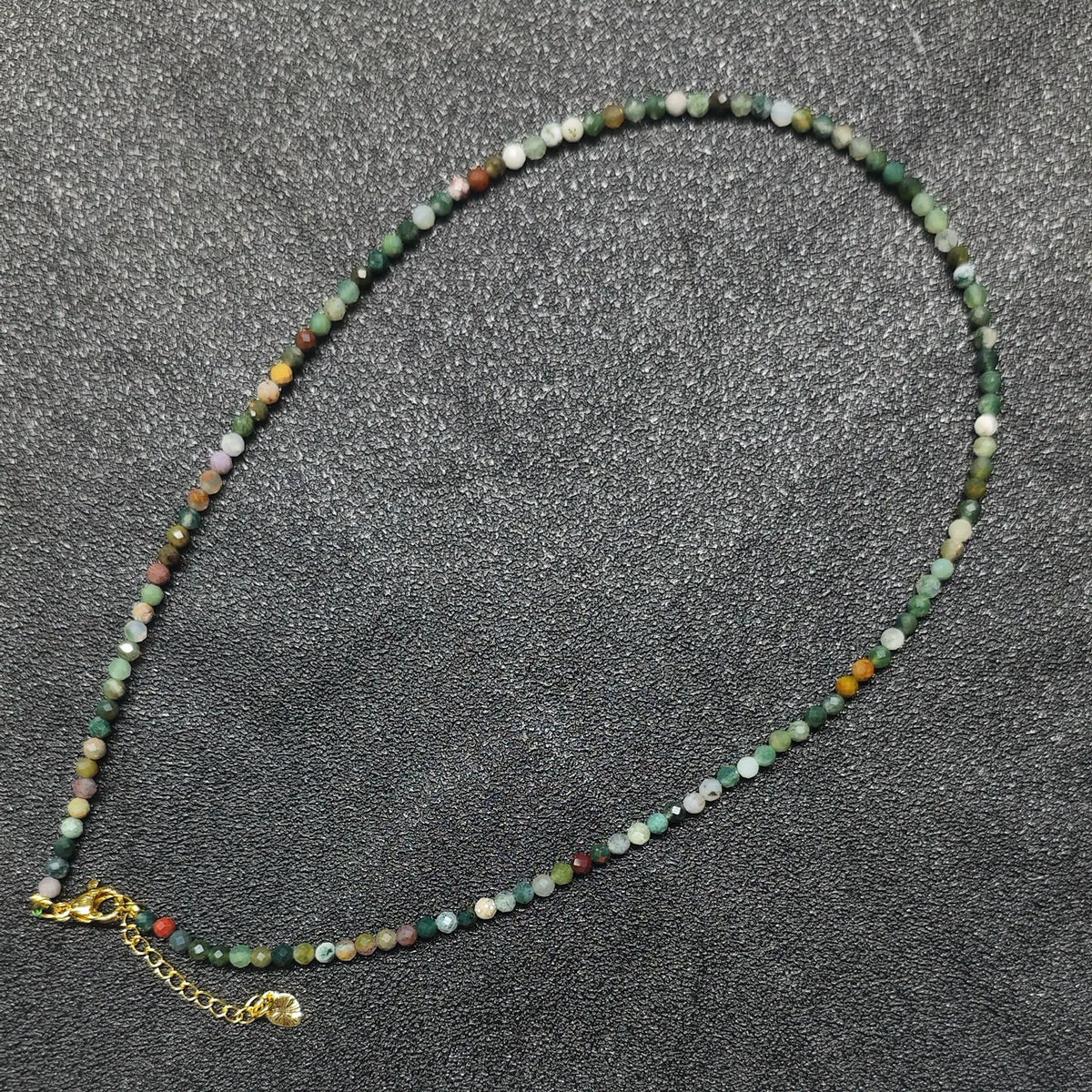 Faceted ocean jasper gemstone necklace strand with 3mm beads and gold extension chain layout