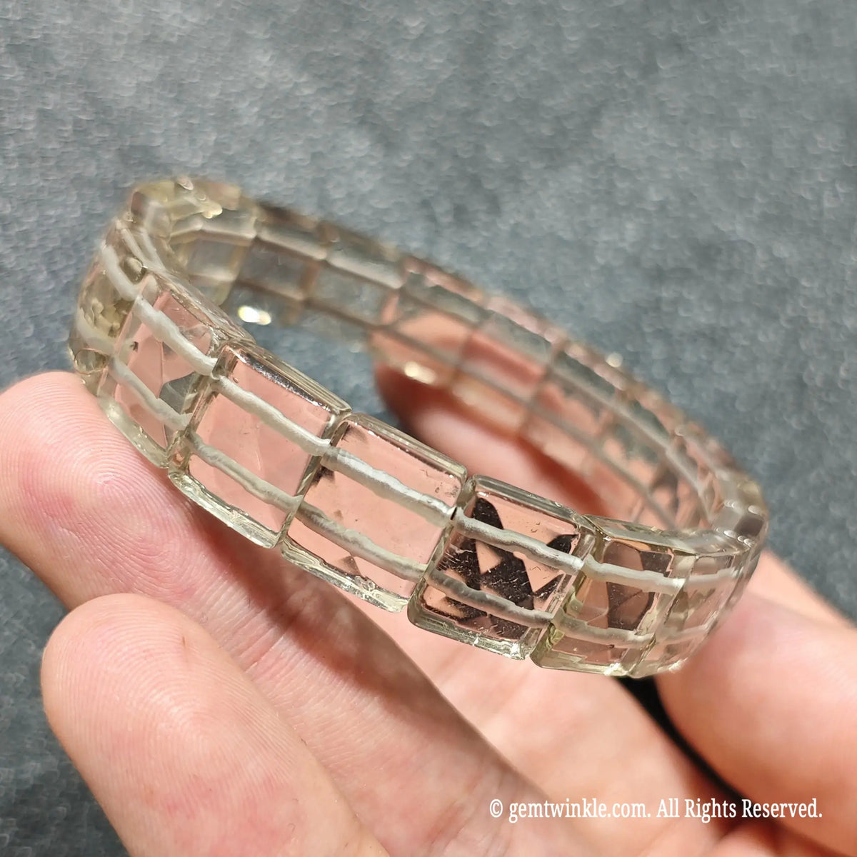 Side angle view of a faceted smoky quartz bar cut wristband displaying smooth rectangular polished tea quartz beads