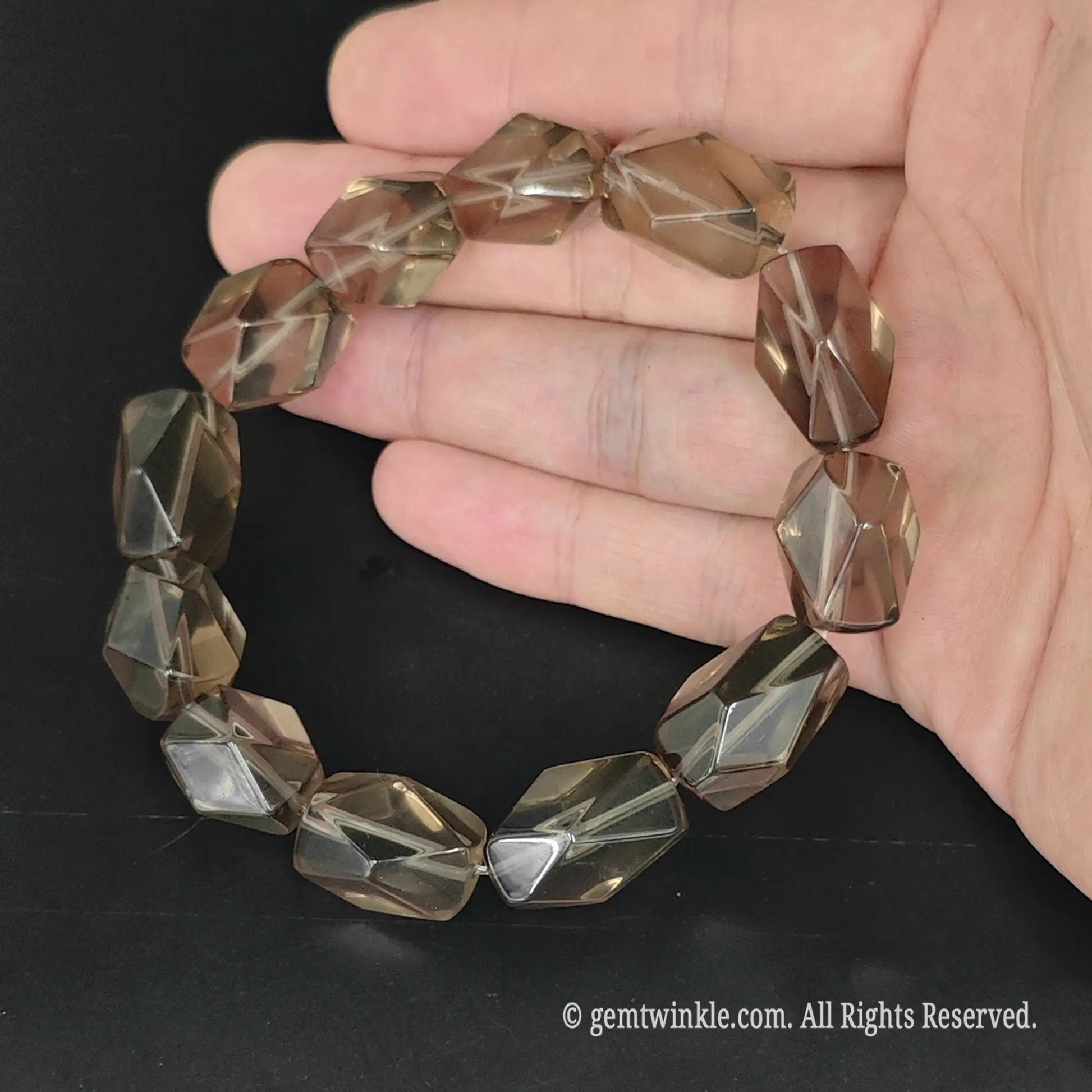 faceted tea quartz freeform bead stretch bracelet shown in open palm