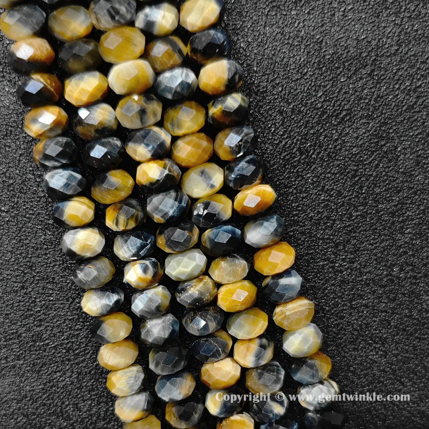 Perspective view of faceted tiger eye wheel shape beads showing light reflection and cut edges