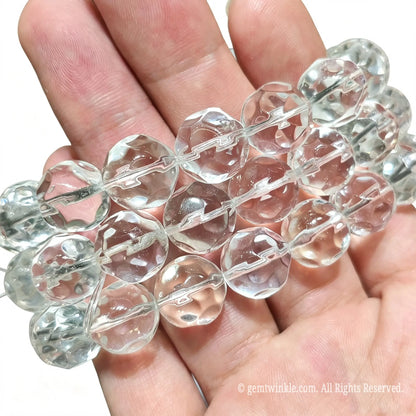 Faceted quartz bead bracelet stack detail view displaying transparent clear quartz pineapple cut beads in hand