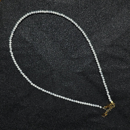 Natural faceted white howlite turquoise necklace with 3mm beads and gold extender chain layout