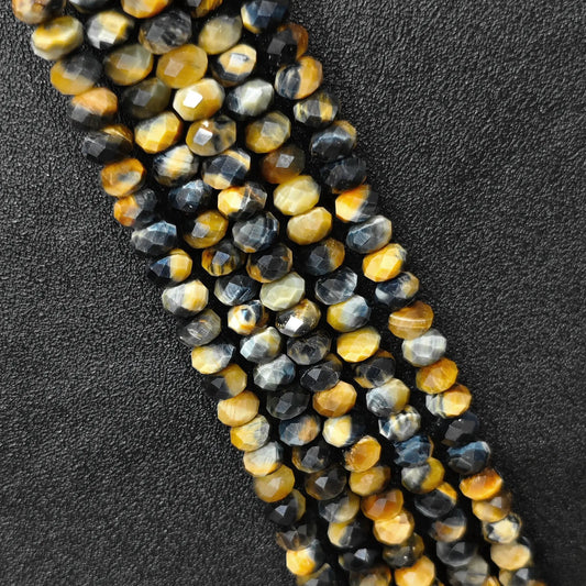 Macro closeup of fancy tiger eye faceted rondelle beads 8x5mm showing chatoyant multi color sheen