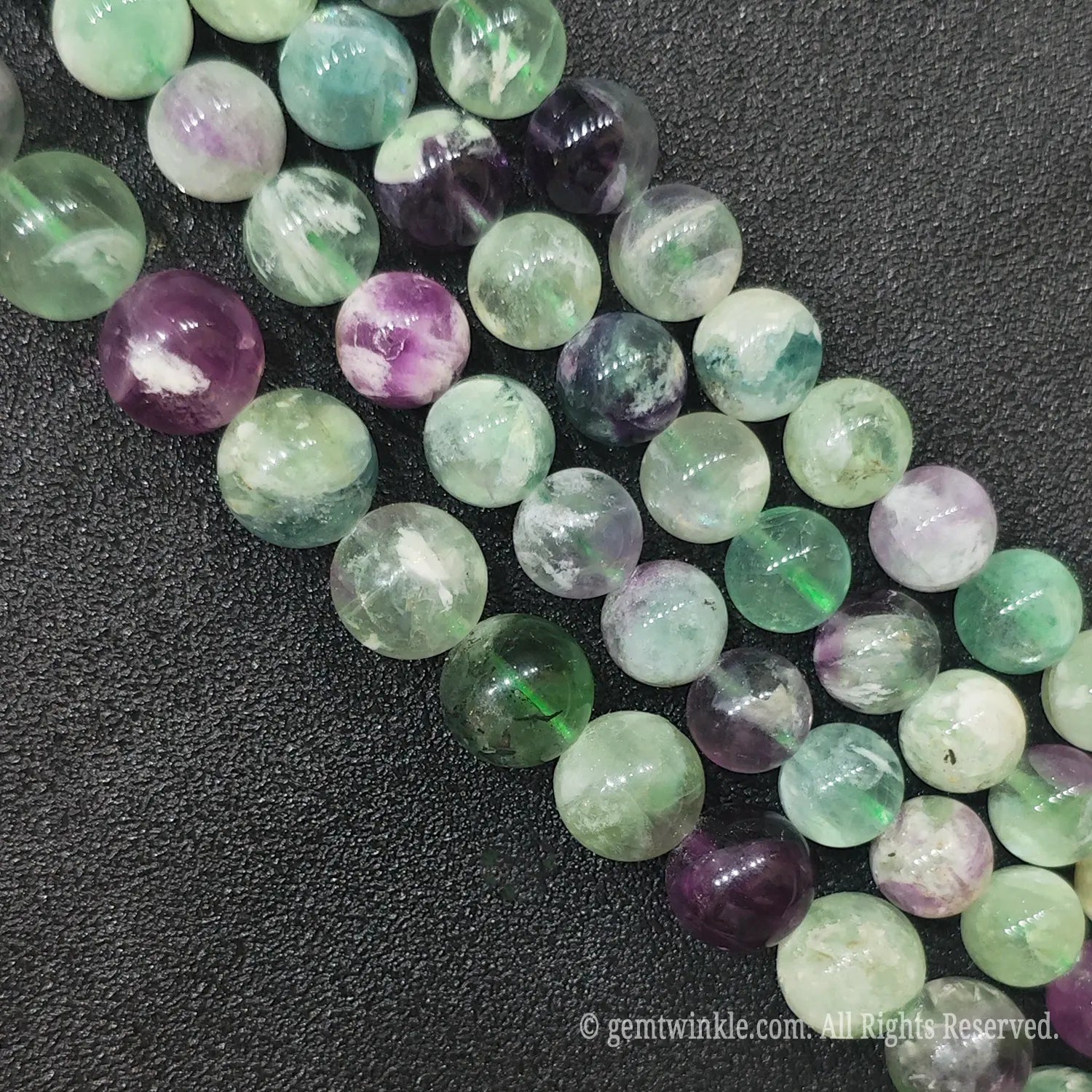 Multiple strands of natural feather fluorite loose beads with vibrant purple green and translucent white colors directly from Donghai crystal market