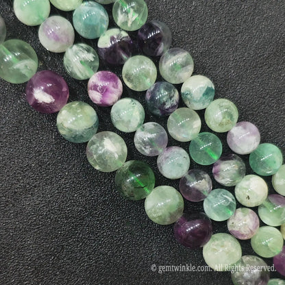 Multiple strands of natural feather fluorite loose beads with vibrant purple green and translucent white colors directly from Donghai crystal market